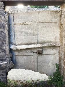Plaster cast of the inner side of a door found in situ in the rear entrance of residence with a wooden bar and iron lock and latch fittings